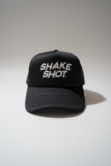 Black cap with 'SHAKE SHOT' text on a white background