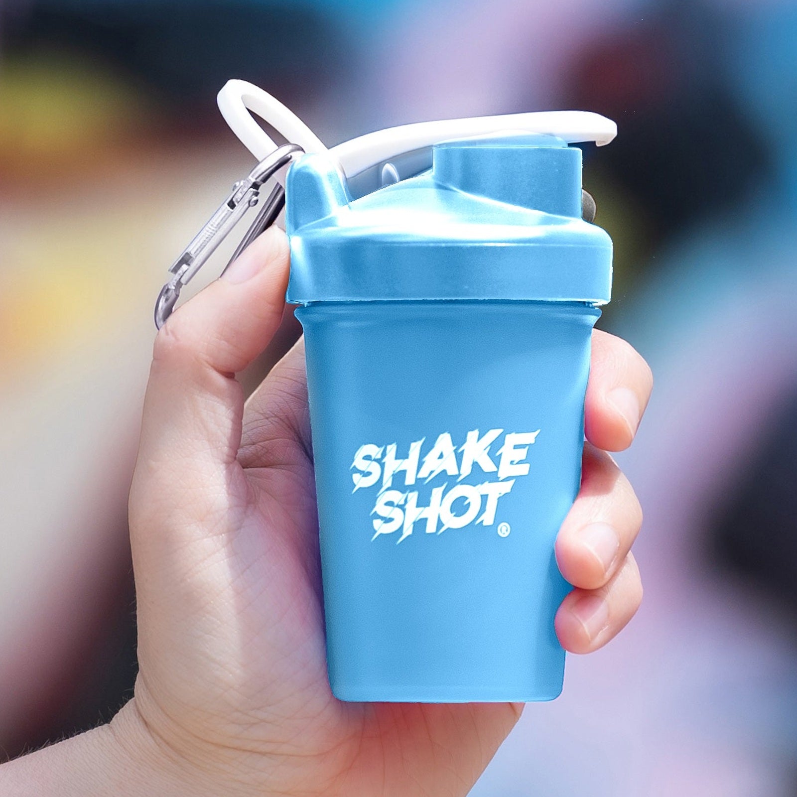 Shake Shot 4 oz blue mini shaker bottle held in hand