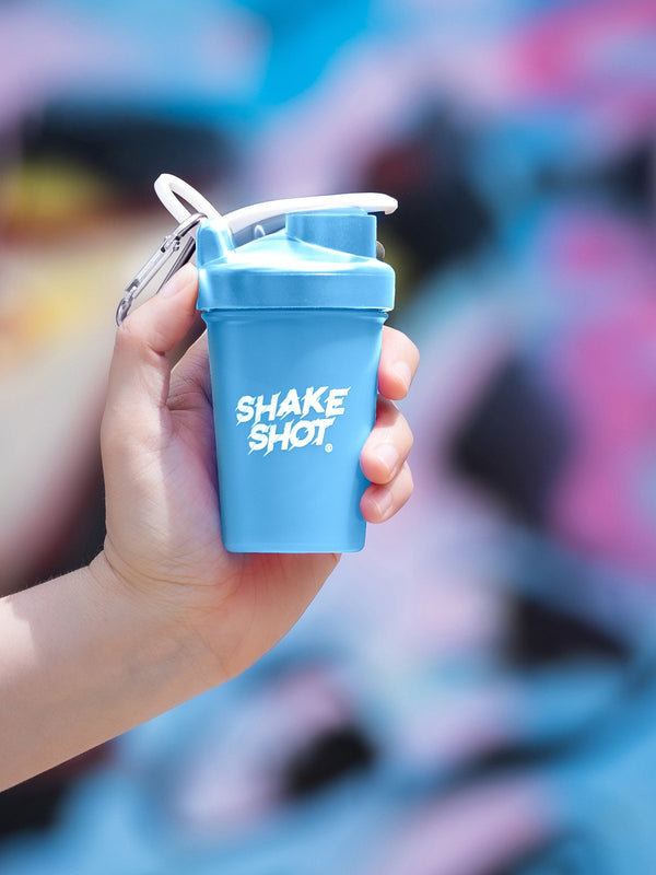 Shake Shot 4 oz blue mini shaker bottle held in hand